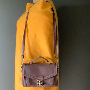 Go with every thing purse in brown with unique front latch and removable strap.